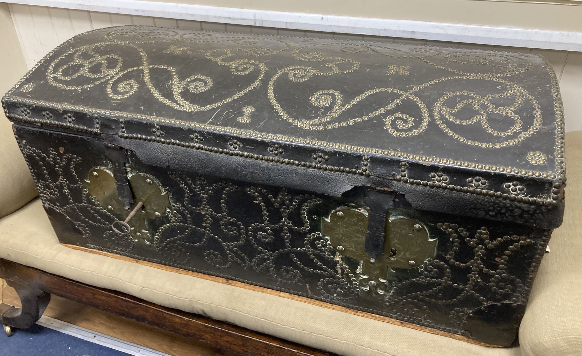 An 18th century Dutch brass mounted and studded leather covered domed top trunk, length 116cm, depth 50cm, height 48cm